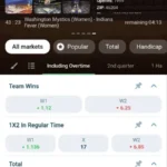 1xBet Android app screenshot: live WNBA basketball match with arena info, 1X2 and total markets